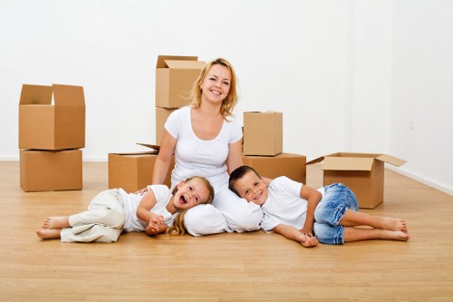 Movers handling furniture and boxes for a flat relocation in Ilford